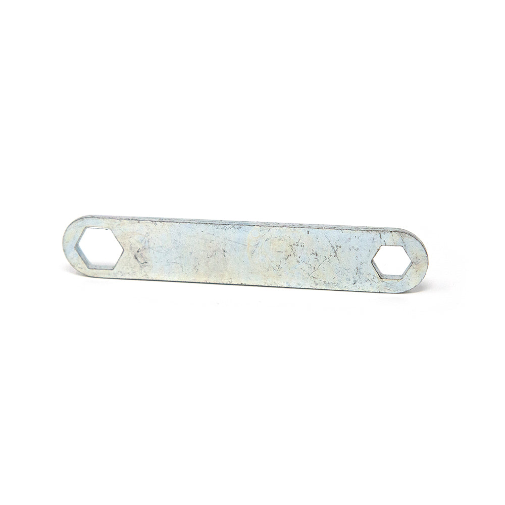 Double sided wrench propped up on its side.