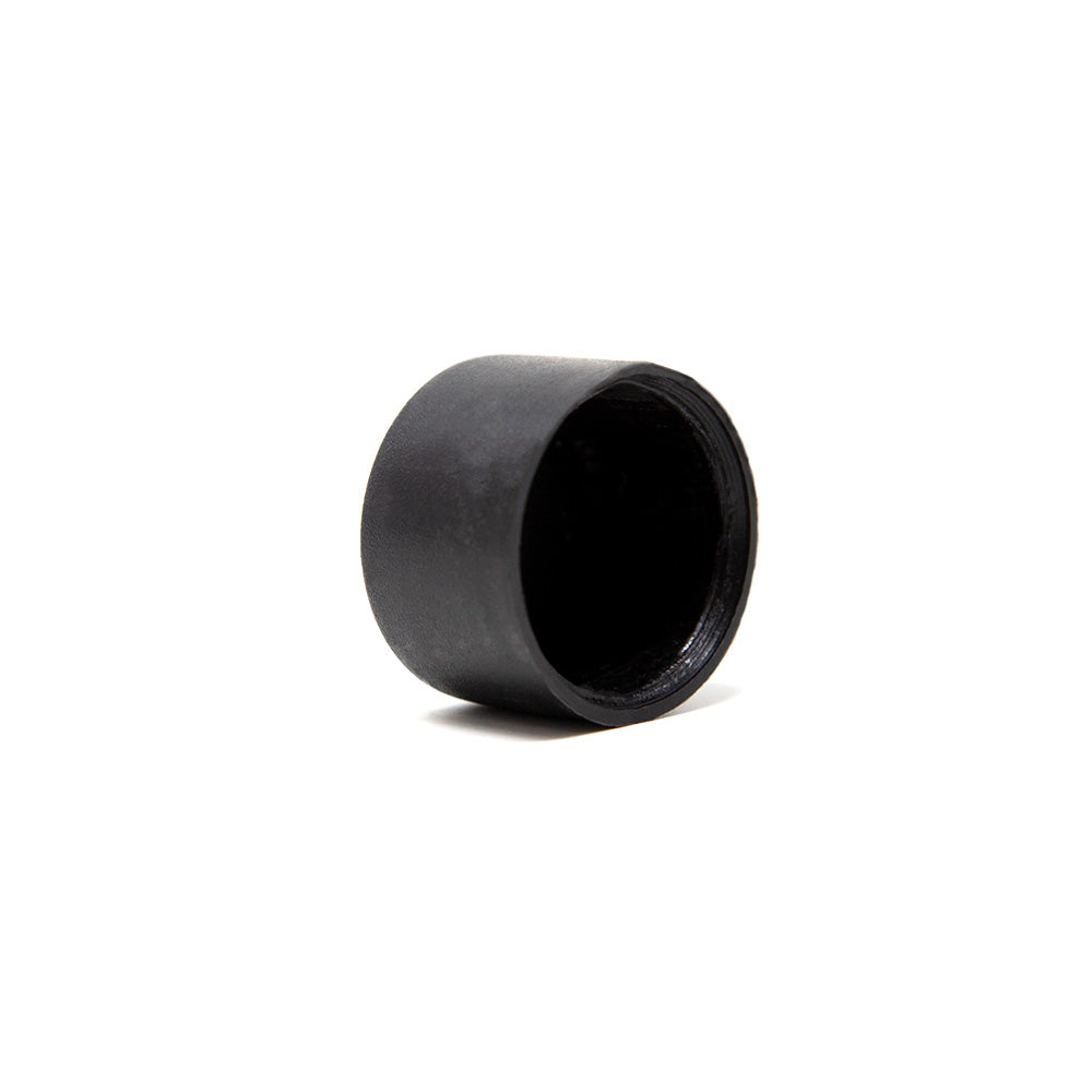 Black tube cap balanced on its side.