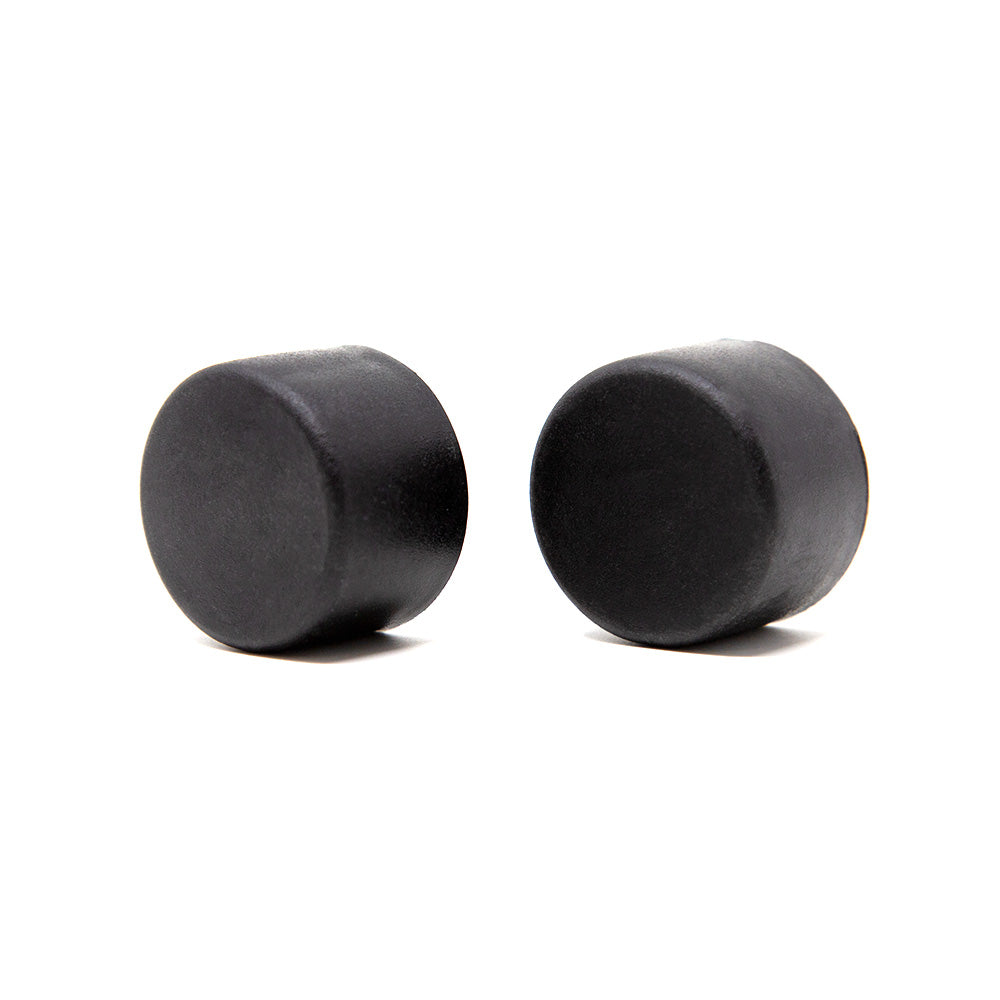Two rubber black tube caps next to each other.