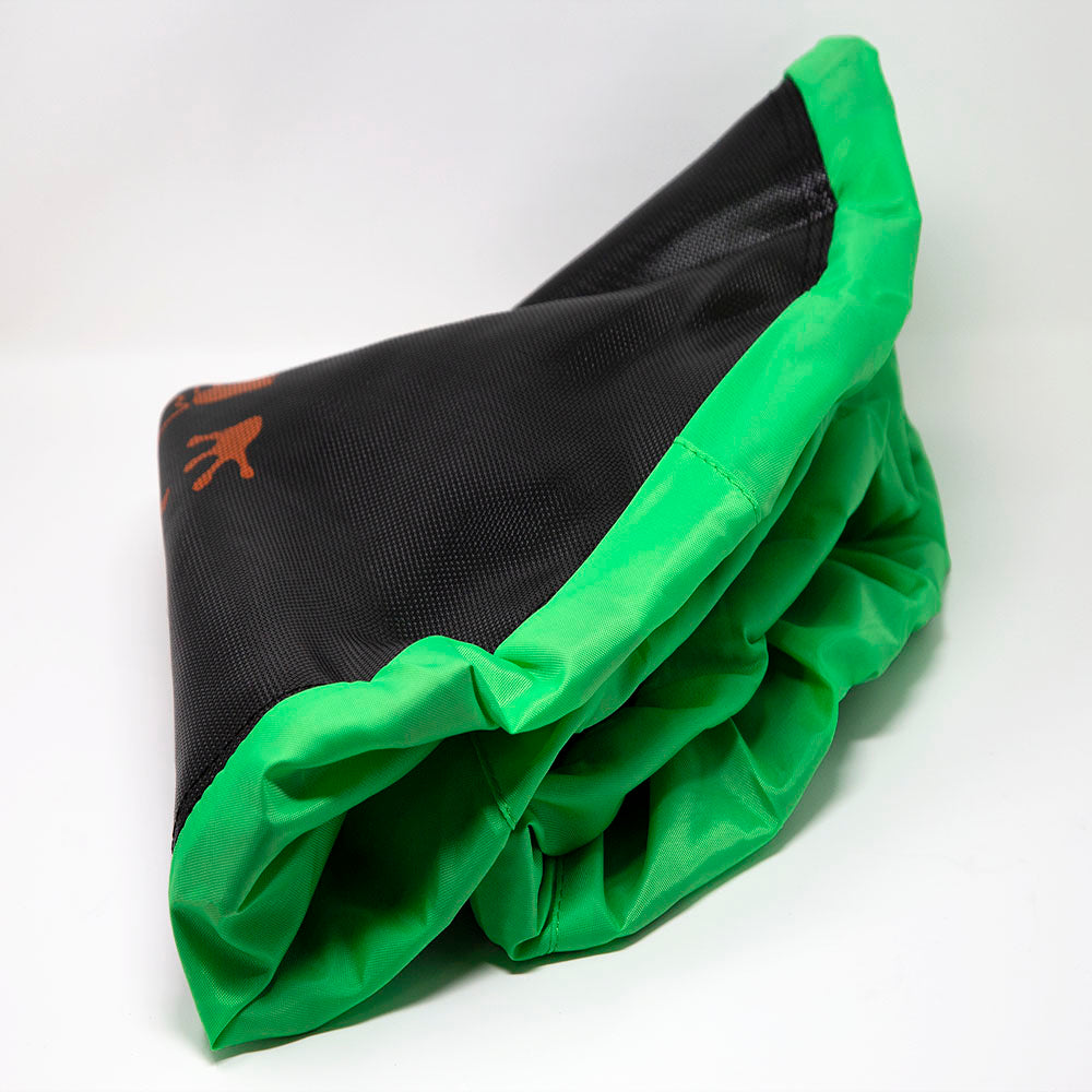 The black jump mat is trimmed with the attached green spring pad.
