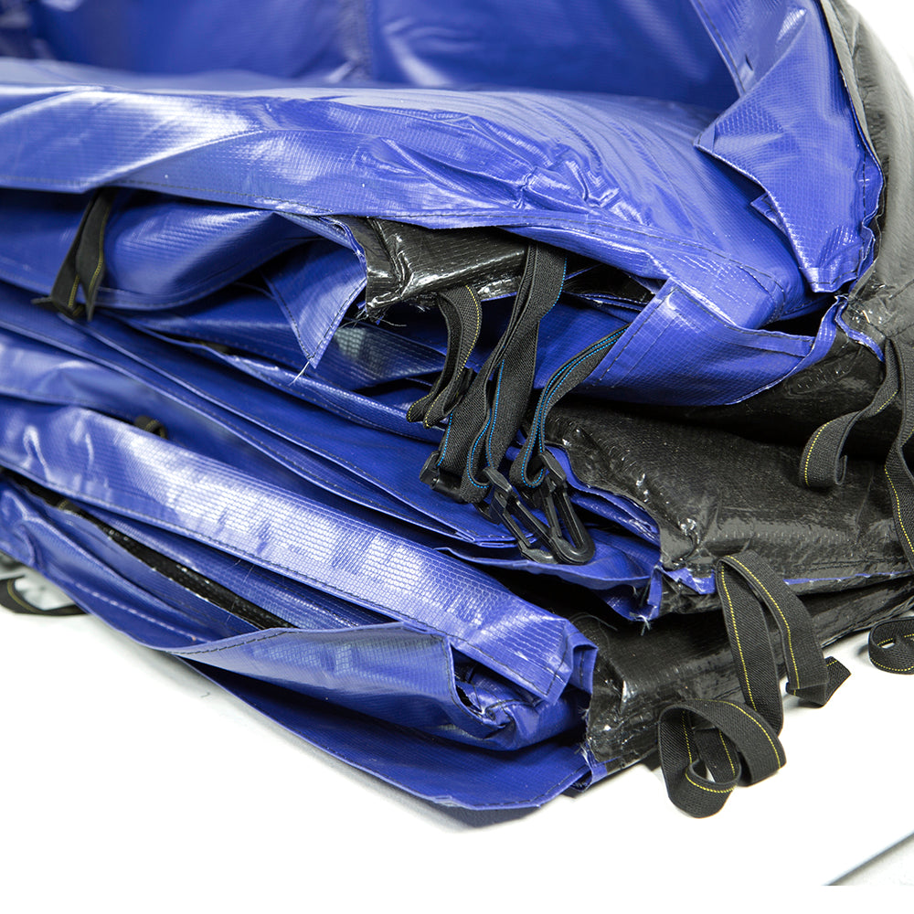 The blue spring pad has black straps to help secure the spring pad to the trampoline frame.