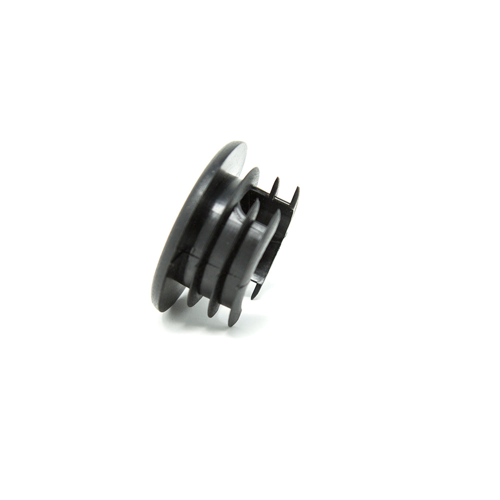 Black end cap balanced on side.