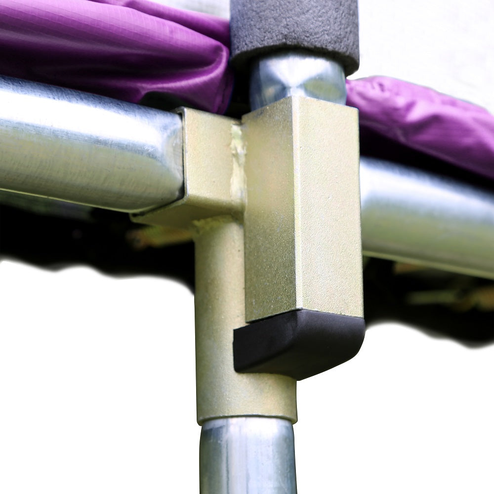 Purple jump mat lays on top of the trampoline frame next to the t-socket.