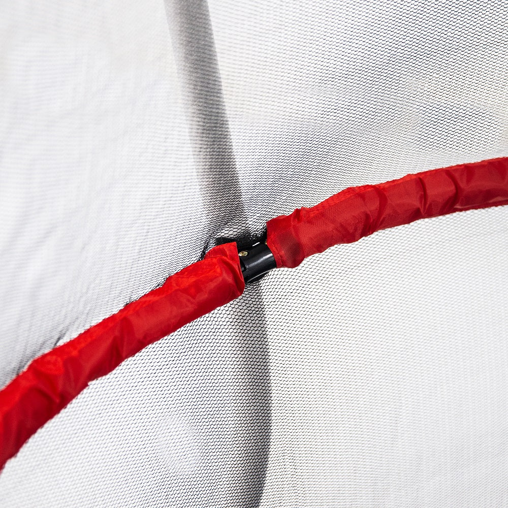 Red padded handlebar on inside of enclosure net, and white enclosure pole outside of the enclosure net.
