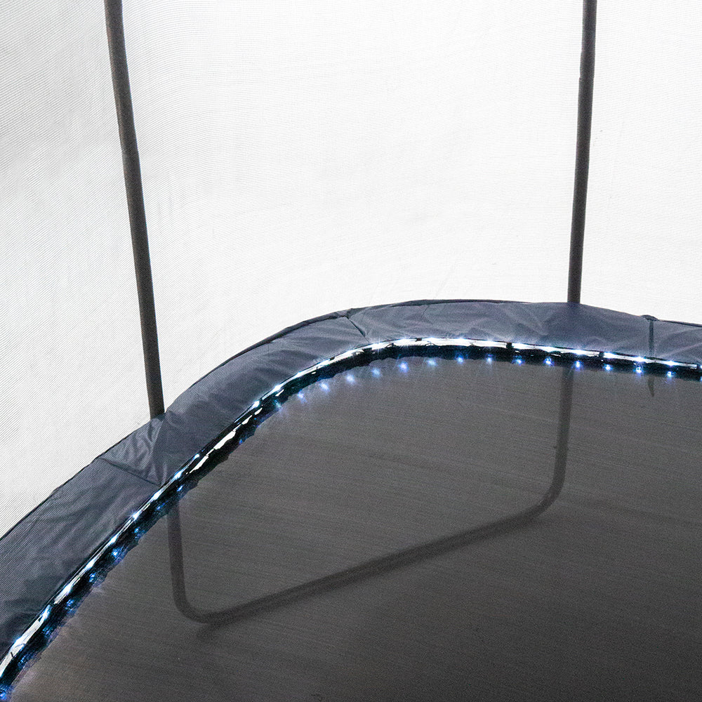 Navy spring pad is lit up with LED lights surrounding its perimeter.