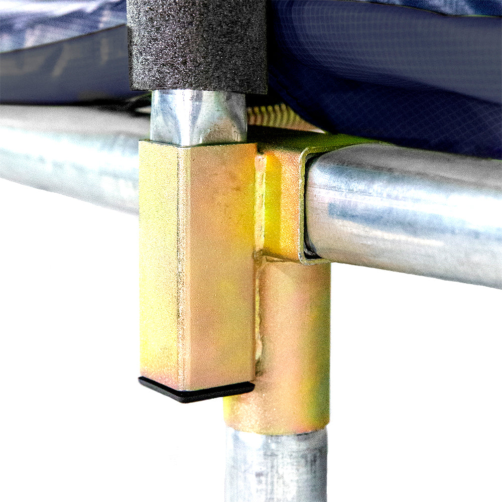 The navy spring pad covers the trampoline frame above the gold-colored T-socket.
