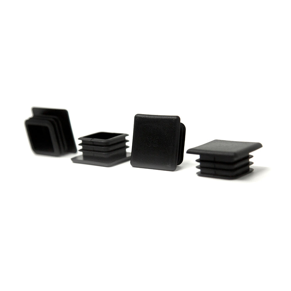 Four plastic end caps lying in a row. 