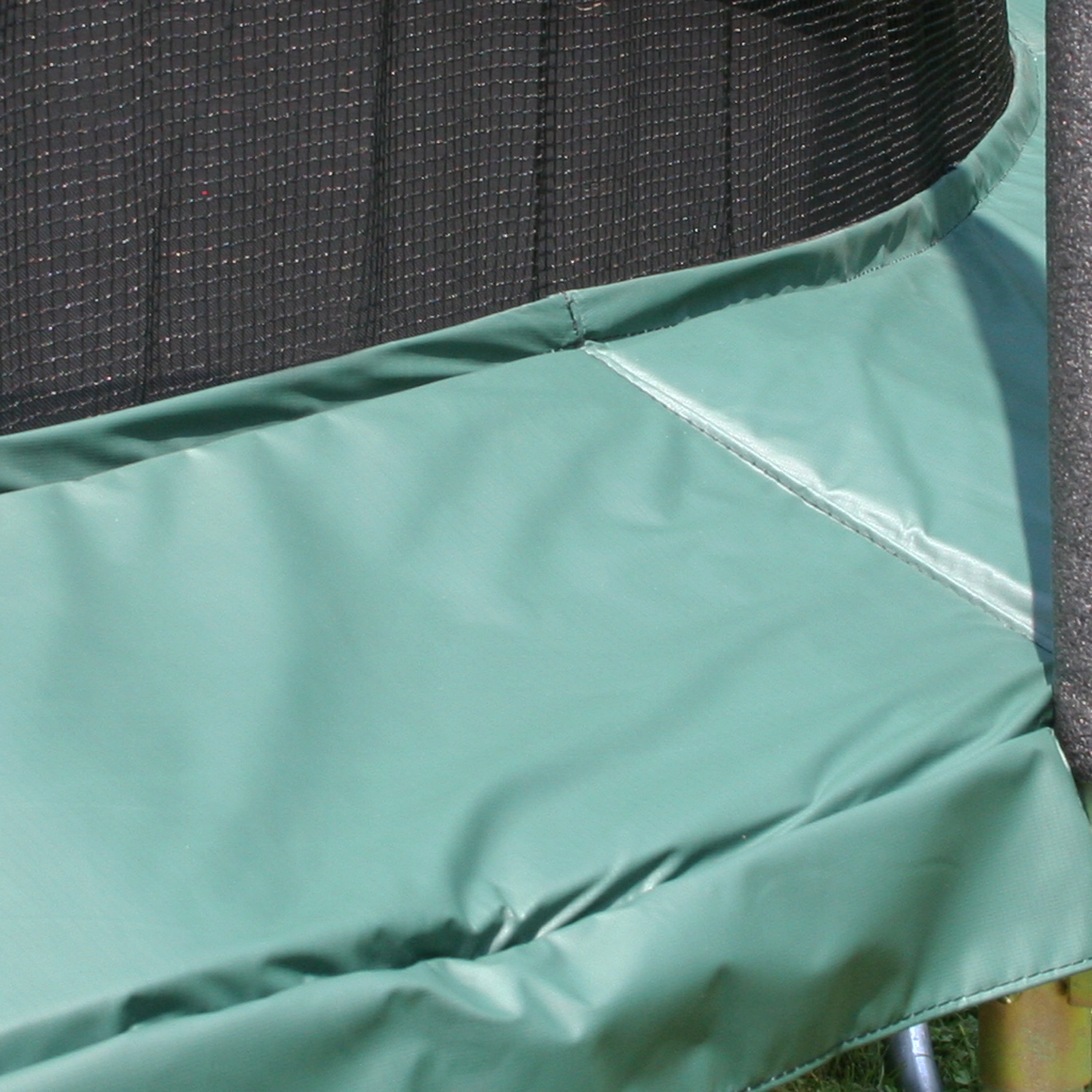 The green spring pad as seen on a 15-foot round trampoline. 