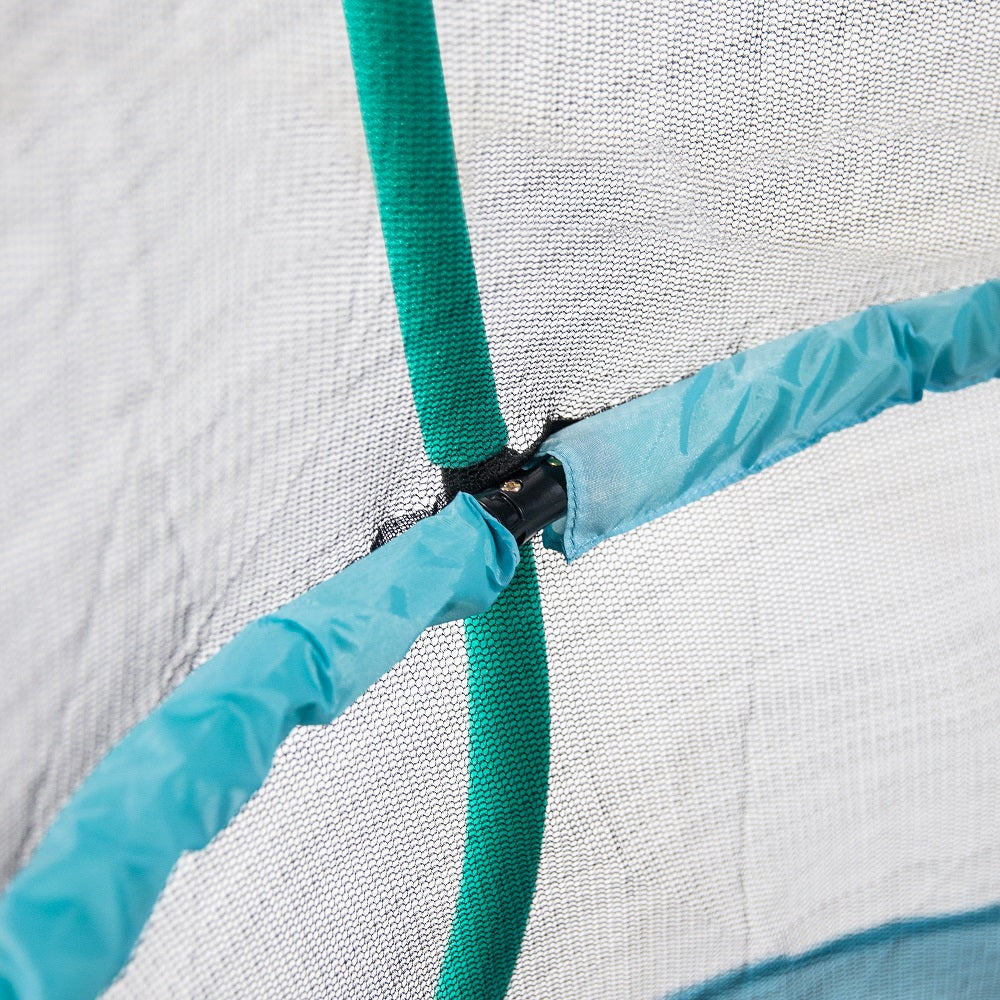 Black enclosure net is in between seafoam green foam-padded enclosure pole and padded light blue handlebar. 