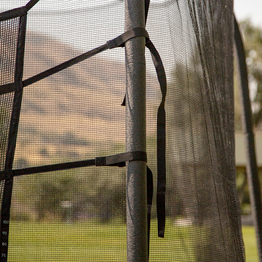 Closer view of the Triple Toss Game's straps tied around the enclosure poles. 